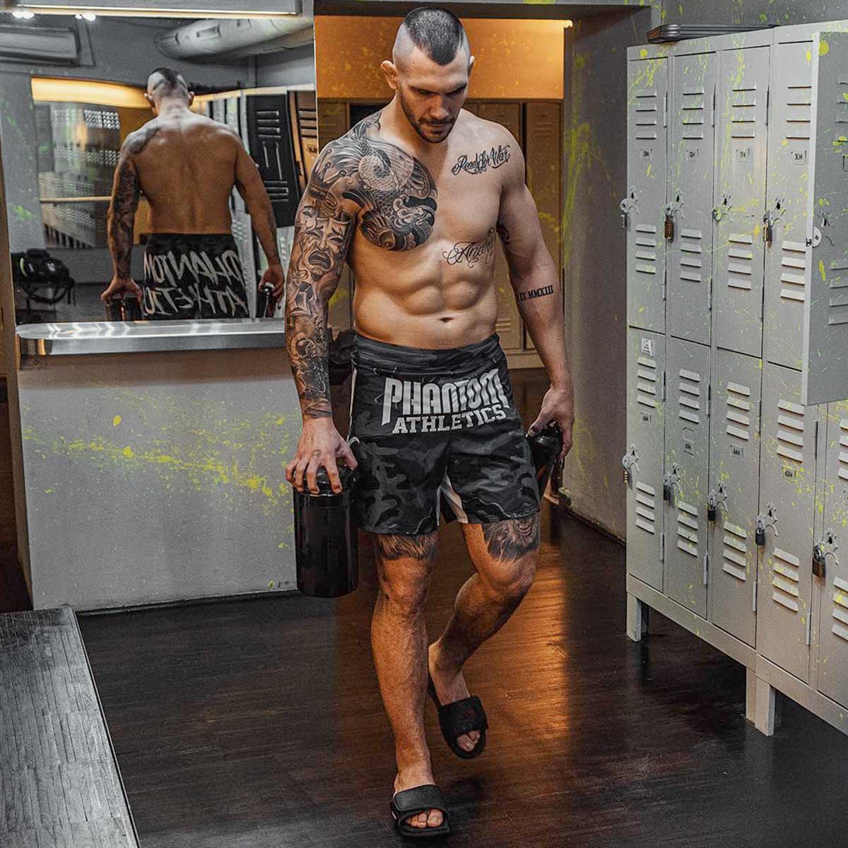 Die Phantom FLEX Fightshorts zählen zu den besten Fightshorts am Markt. Ultraleicht, mega flexibel und reißfest. Reduziert auf ein absolutes Minimum bietet sie dir maximale Performance in deinem Kampfsport. Egal ob BJJ, MMA, Muay Thai oder Kickboxen. Die FLEX Shorts von Phantom Athletics holen das beste aus dir raus. Hier im beliebten Urban Camo Look in schwarz/grau und großem Phantom Athletics Schriftzug auf der Rückseite.  UFC MMA Fighter Aleks Rakic beim Training.